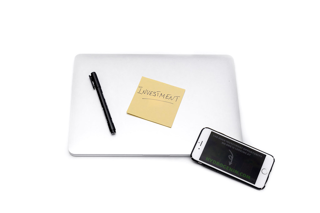 Investment sticker, laptop and smartphone