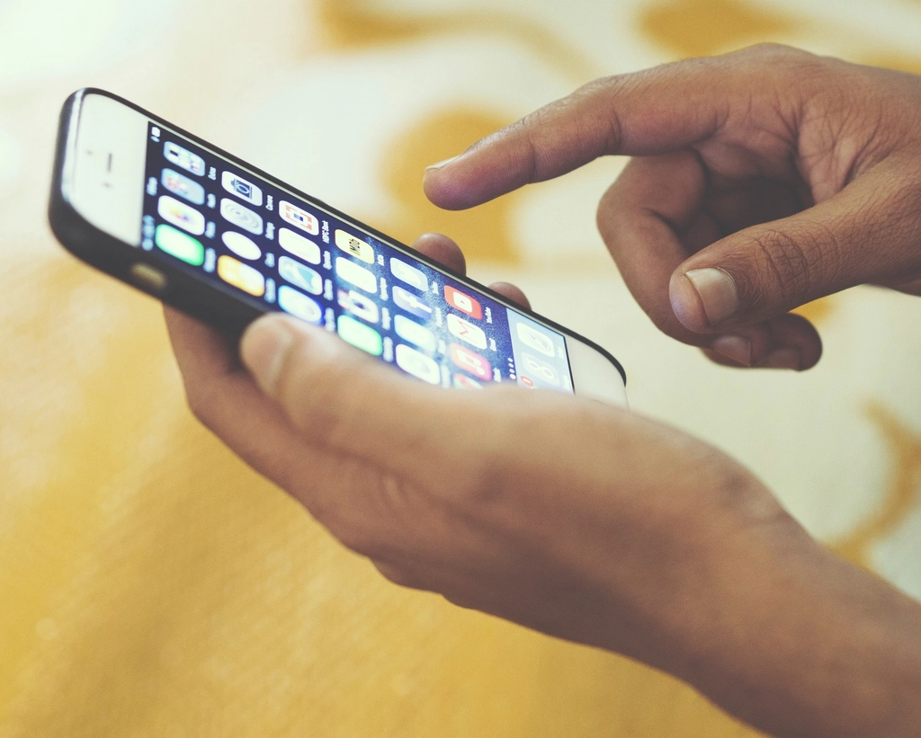 Hand swiping iPhone screen, location